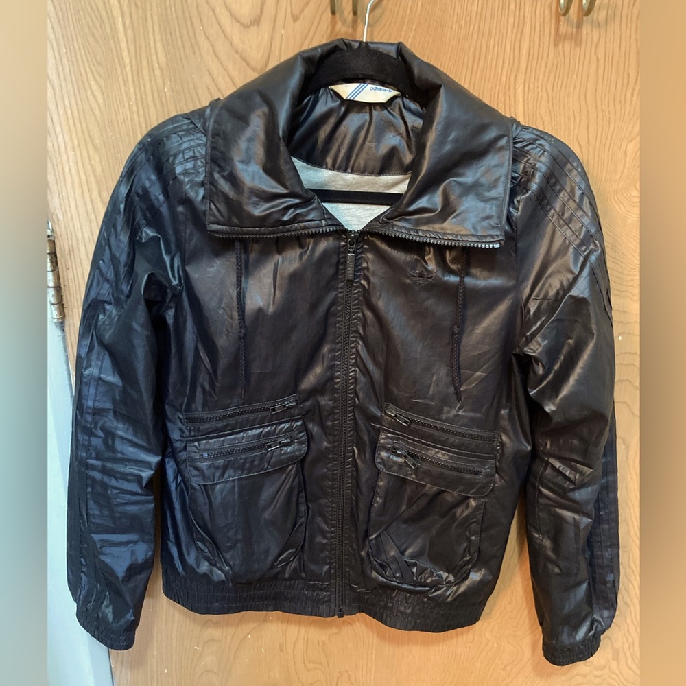 Adidas women’s windbreaker with foldable hood, and cotton lining - size small